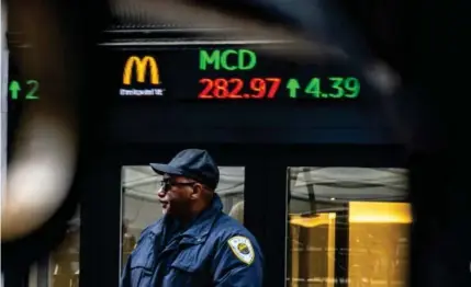  ?? AP PHOTO ?? A security personnel stands at one of the entrances of the New York Stock Exchange on March 20, 2024.