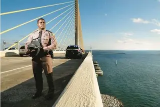  ?? DOUGLAS R. CLIFFORD/TIMES ?? Tabarie Sullivan with the Florida Highway Patrol volunteers to patrol the Sunshine Skyway bridge and has intercepte­d some 10 people before they could jump.