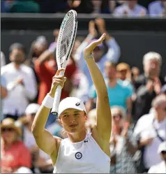  ?? ALBERTO PEZZALI/AP ?? Iga Swiatek celebrates after beating Jana Fett in the first round at Wimbledon on Tuesday. The victory was her 36th in row and is the longest winning streak on the women’s tour since Martina Hingis won 37 in a row in 1997.