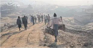  ?? REUTERS ?? Rohingya refugees walk at Jamtoli camp in Cox’s Bazar, Bangladesh.