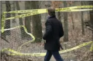  ?? SETH WENIG — ASSOCIATED PRESS ?? A man walks past police tape on Thursday near the park in which the bodies of four men were found in Central Islip.