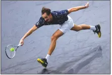  ?? (AP/Christophe Ena) ?? Russia’s Daniil Medvedev stretches to return the ball to Germany’s Alexander Zverev during the Paris Masters final Sunday. Medvedev earned his eighth career title and third at a Masters event with a 5-7, 6-4, 6-1 victory.