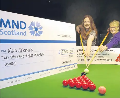  ??  ?? A SNOOKER exhibition in Dundee by former World Champion John Higgins has raised more than £2,000 for a national charity.
John, the winner of four crucible titles, was at the Tivoli Club for the exhibition. He played nine members of the public, as well...