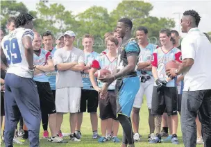  ??  ?? Masterclas­s: NFL stars Brandon Carr, Will Blackmon and Cameron Wake give a coaching clinic to the Farnham Knights and the 27th Regiment of the Royal Logistics Corps. PICTURES BY MARK SANDOM