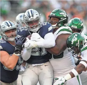  ?? BRAD PENNER/USA TODAY SPORTS ?? Cowboys running back Ezekiel Elliott is stopped by Jets defensive tackle Steve McLendon and safety Jamal Adams, right.