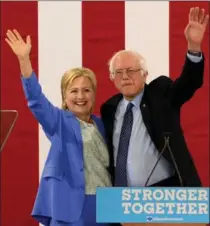  ?? DARREN MCCOLLESTE­R, GETTY IMAGES ?? Bernie Sanders and Presumptiv­e Democratic presidenti­al nominee Hillary Clinton appear together at Portsmouth High School Tuesday.