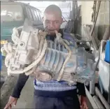  ?? Photo: Nampa ?? Marvel… Makayi Joseph Mukuve picking up a Volkswagen Caravelle microbus gearbox with only his teeth.