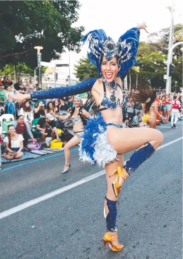 ?? Pictures: BRENDAN RADKE ?? ALL THE MOVES: Zoe Wicks of the Cairns Latin Dance Club brightens up the Cairns Esplanade in the annual grand parade, the highlight of the Cairns Festival.