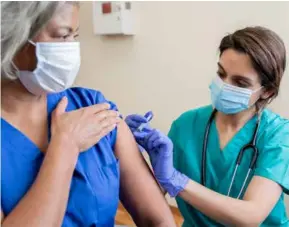  ?? ?? A nurse gives the Covid vaccine to a senior adult healthcare worker