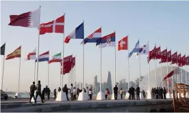  ?? Photograph: Karim Jaafar/AFP/Getty Images ?? The flags of qualifying nations are raised along the Doha Corniche as the countdown to the World Cup gathers pace.