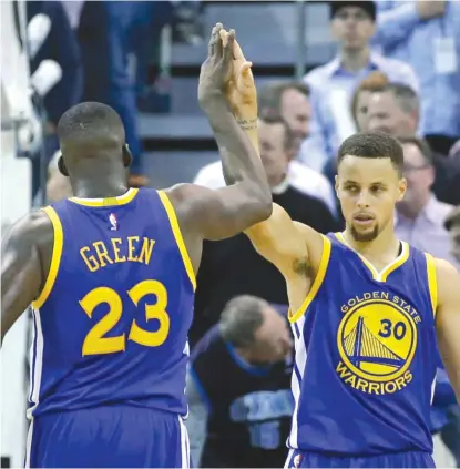  ?? | AP ?? Warriors star Stephen Curry (getting a high-five fromDraymo­nd Green) already has made a record 293 three-pointers this season.