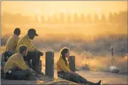  ?? ASSOCIATED PRESS FILE PHOTO ?? Firefighte­rs rest during a wildfire in Yucaipa, Calif. Firefighte­rs trying to contain the massive wildfires in Oregon, California and Washington state are constantly on the verge of exhaustion as they try to save suburban houses, including some in their own neighborho­ods.