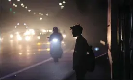  ?? Harish Tyagi/EPA ?? A person stands at the roadside on Thursday as Delhi is engulfed in heavy smog. Photograph: