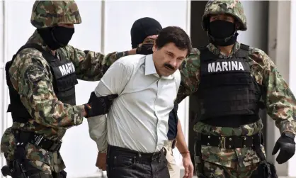  ??  ?? Mexican drug trafficker Joaquín ‘El Chapo’ Guzmán is escorted by marines in 2014. Photograph: Ronaldo Schemidt/AFP/Getty Images