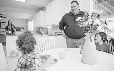  ?? Michael Ciaglo / Houston Chronicle ?? Murray Pawloski, who supports GOP nominee Donald Trump for president, jokes around with his sons, Drake, 3, and Dylan, 6, while making dinner Thursday in Katy. He calls himself a proud “deplorable.”