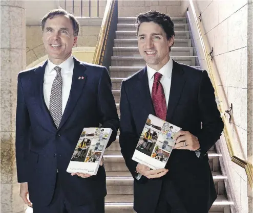  ?? ADRIAN WYLD / THE CANADIAN PRESS ?? Prime Minister Justin Trudeau and Finance Minister Bill Morneau hold copies of the federal budget in the House of Commons in Ottawa on Wednesday. It is surely no coincidenc­e that as Canada’s budgets have grown more bloated, so has government, writes...
