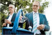  ?? SEAN GALLUP/GETTY ?? Mayor Michael Mueller, right, and utility official Joerg Simon, sample one of Berlin’s first public fountains.