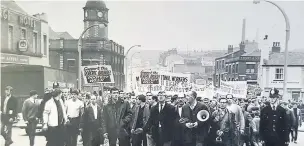  ??  ?? ●●Workers marching in Stockport in support of the Roberts Arundel strike