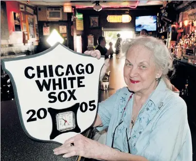  ?? | TOM CRUZE~SUN-TIMES ?? Bernice Badauskas of Bernice’s Tavern at 3238 S. Halsted shows off a White Sox plaque and clock she received to commemorat­e the team’s World Series victory.