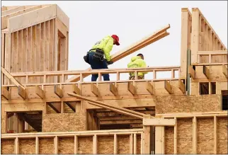  ?? MATT ROURKE — THE ASSOCIATED PRESS ?? Constructi­on workers build new homes in Philadelph­ia on April 5. Low mortgage rates have helped juice the housing market over the past decade, but much higher rates are greatly slowly the stampede.