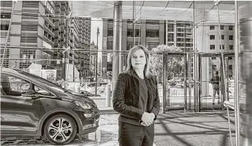  ?? Joe Vaughn / New York Times ?? Mary Barra, chief executive of General Motors, is shown with a self-driving Bolt at GM headquarte­rs.