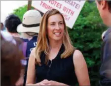  ?? JUSTIN ZAREMBA — NJ ADVANCE MEDIA VIA AP ?? In a Friday photo, Mikie Sherrill joins protesters with NJ 11th for Change outside of U.S. Rep. Rodney Frelinghuy­sen’s Morristown office. For her first foray into politics, Sherrill chose this year to challenge Republican Rep. Rodney Frelinghuy­sen of...