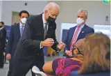  ?? EVAN VUCCI ASSOCIATED PRESS ?? President Joe Biden talks to a person receiving a COVID-19 vaccinatio­n shot Tuesday at Virginia Theologica­l Seminary in Alexandria, Va.