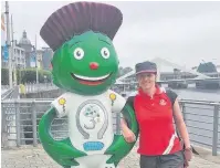  ??  ?? Alex Bliss volunteeri­ng at the 2014 Commonweal­th Games in Glasgow, posing next to Thistle, one of 25 official mascots of the games.