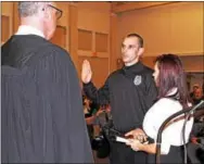  ?? CHRIS BARBER – DIGITAL FIRST MEDIA ?? Raymond Sullivan, center is sworn in as a member of the Southern Chester County Regional Police by District Judge Matt Seavey.