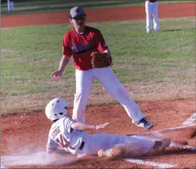  ?? Scott Herpst ?? Chattanoog­a Valley’s Kade Stone comes sliding home to score as Saddle Ridge pitcher Parker Hayes moves in to cover the plate. The Eagles took the win over the Mustangs in a JV game at Ridgeland High School last week.