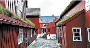  ??  ?? Tinganes, a historic area in the capital of the Faroe Islands, has red government buildings with grass turf roofs.