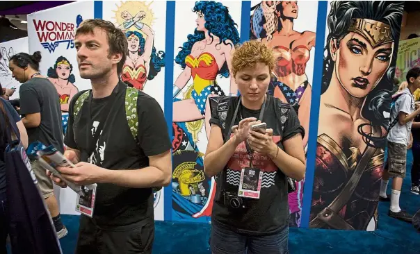  ??  ?? Having a good time: Fans mingling on the convention floor during the third day of Comic Con 2016 in San Diego, California. — EPA