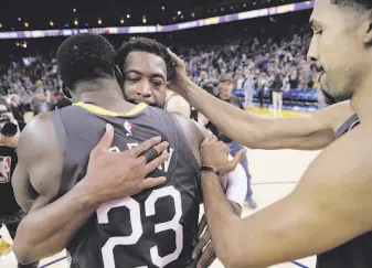  ??  ?? The Warriors’ Draymond Green (23) and Shaun Livingston (right) hug Miami’s Dwyane Wade after Golden State’s victory. Wade is expected to retire after the season, his 16th in the NBA.