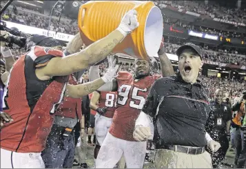 ?? MARK HUMPHREY / AP ?? Falcons coach Dan Quinn (reacting to a celebrator­y soaking after Sunday’s NFC title game) was the defensive coordinato­r for the Seahawks in back-to-back Super Bowl appearance­s, going 1-1.