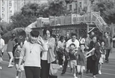  ?? PHOTOS PROVIDED TO CHINA DAILY ?? Left: Kangjian is escorted by his mother Xiaobei to leave the kindergart­en where other children and parents have misunderst­andings about his behavior. panics when frightened and whistles to ask for help because he barely talks.