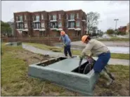  ?? GRAY WHITLEY/SUN JOURNAL VIA AP ?? City of New Bern technician­s work to access an electrical utility box at East Front Street in New Bern, N.C., Saturday, Sept. 15, that was destroyed by storm surge from Hurricane Florence.