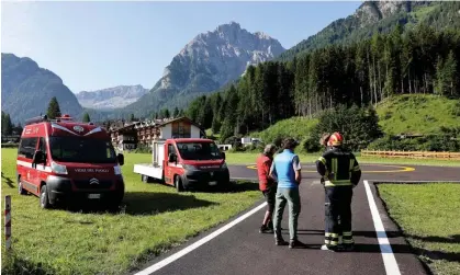  ?? Photograph: Andrea Solero/EPA ?? Rescue teams gather at the bottom of the Marmolada mountain in the aftermath of Sunday’s avalanche.