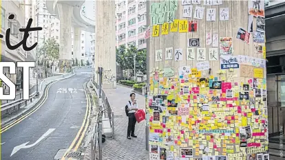  ??  ?? A man looks at a Lennon Wall on the side of a highway pillar on Hill Road in Sai Ying Pun.