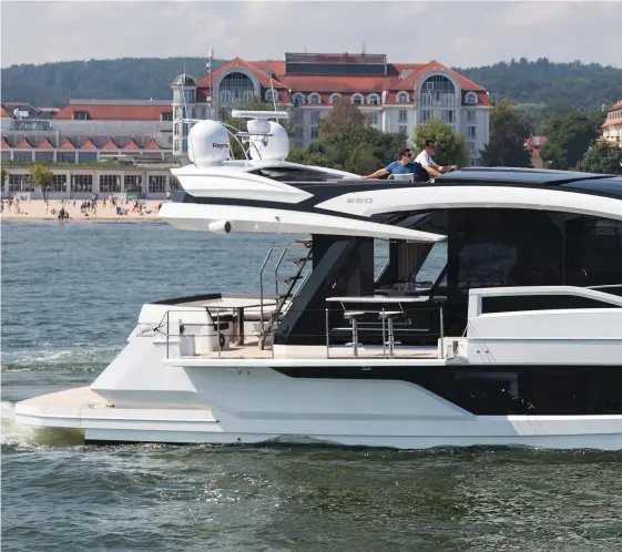  ??  ?? The Galeon 650 Skydeck cruises off the beachfront in the Baltic resort of Sopot. Note the side terrace and carbon top that closes off the flybridge.