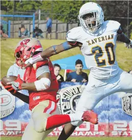  ??  ?? RISING TIDE: Despite extending himself to the fullest, Xaverian’s Ike Irabor, right, can’t keep Everett’s Isaiah Likely from a touchdown catch. At right, Everett teammates Mike Sainristil, left, and Jaden Mahabir leap to celebrate Mahabir’s...