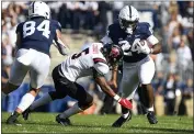  ?? BARRY REEGER — THE ASSOCIATED PRESS ?? Penn State running back Keyvone Lee (24) looks to elude Ball State safety Bryce Cosby (5) during an NCAA college football game in State College, Pa., Saturday.