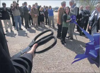  ?? PHOTOS BY MIKE BROWN/THE COMMERCIAL APPEAL ?? This giant pair of scissors cut the ribbon Monday at the official groundbrea­king ceremony for Bayer CropScienc­e’s $17 million facility expansion at the AgriCenter. A separate ceremony was held for Helena Chemical’s expansion.