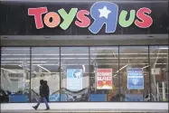  ?? Julio Cortez / Associated Press file photo ?? A person walking near the entrance to a Toys R Us store, in Wayne, N.J. Toys R Us’s management has told its employees that it will sell or close all of its U.S. stores.