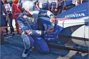  ?? Mykal mceldowney/usa Today sports ?? Chip Ganassi Racing driver Alex Palou (10) puts a sticker on his car after earning the pole position Sunday, May 21, 2023, after Firestone Fast Six qualifying at Indianapol­is Motor Speedway in preparatio­n for the 107th running of the Indianapol­is 500.