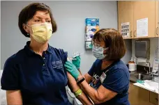  ?? BEN GRAY / ASSOCIATED PRESS ?? Carol Kelly (left) receives a Moderna variant vaccine shot from registered nurse Mary Bower on March 31 at Emory University’s Hope Clinic in Decatur, Ga.