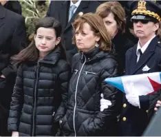  ?? | ASHLEE REZIN/ SUN- TIMES ?? Grace and Erin Bauer at the funeral for Cmdr. Paul Bauer.