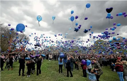  ??  ?? People release balloons outside Alder Hey Children’s Hospital following the death of 23-month old Alfie Evans, who was being treated at the hospital in Liverpool. Alfie is pictured below cuddling his mother Kate James earlier this month.