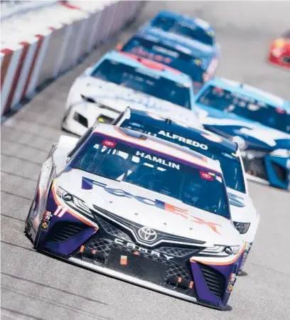  ??  ?? Denny Hamlin, front, has eight top-5 finishes in the opening 10 races, but has yet to reach victory lane.