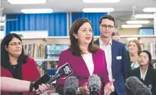  ??  ?? Premier Annastacia Palaszczuk (centre) and Education Minister Grace Grace make an announceme­nt about airconditi­oning in Queensland state schools at Craigslea State High School yesterday.