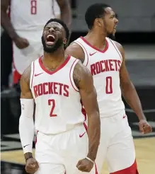  ?? AP ?? WEIGHT OFF THEIR SHOULDERS: With James Harden gone, David Nwaba, left, and Sterling Brown, right, celebrated during the Rockets’ win over the Spurs.